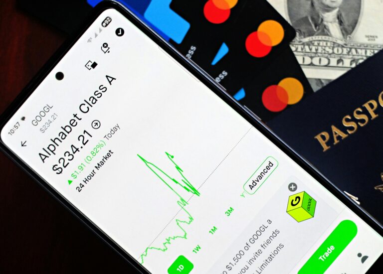 Smartphone displaying stock market app next to U.S. dollar and passport, representing global finance.